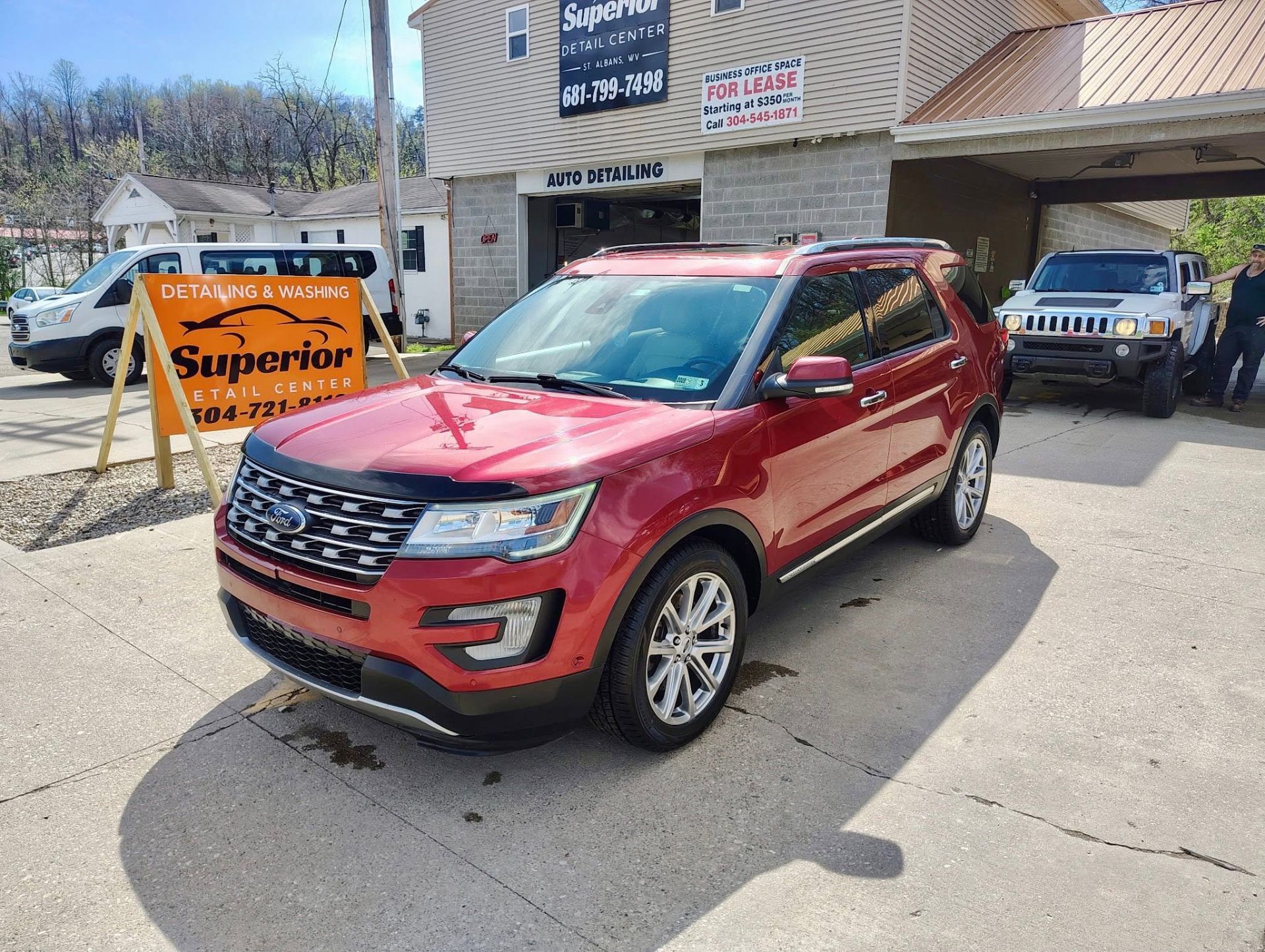 Red Ford Explorer freshly detailed outside the shop